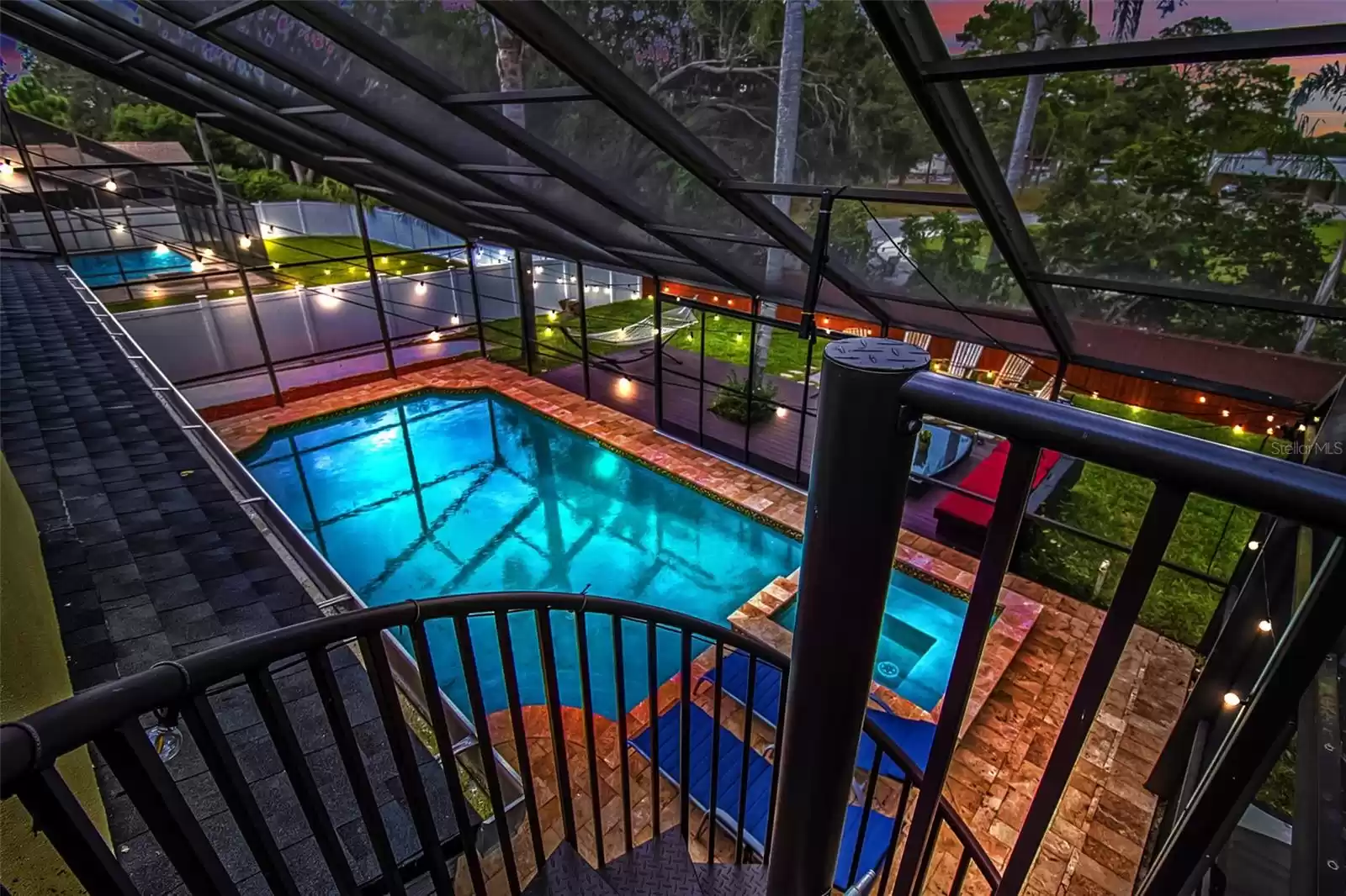 Master bedroom balcony overlooks the massive glistening pool