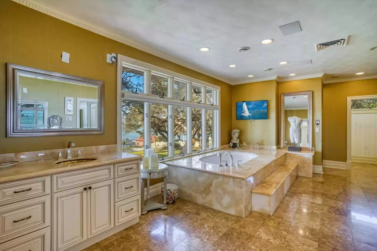The light filled Master Bath is spa-like in size and features a bathtub with sweeping water views