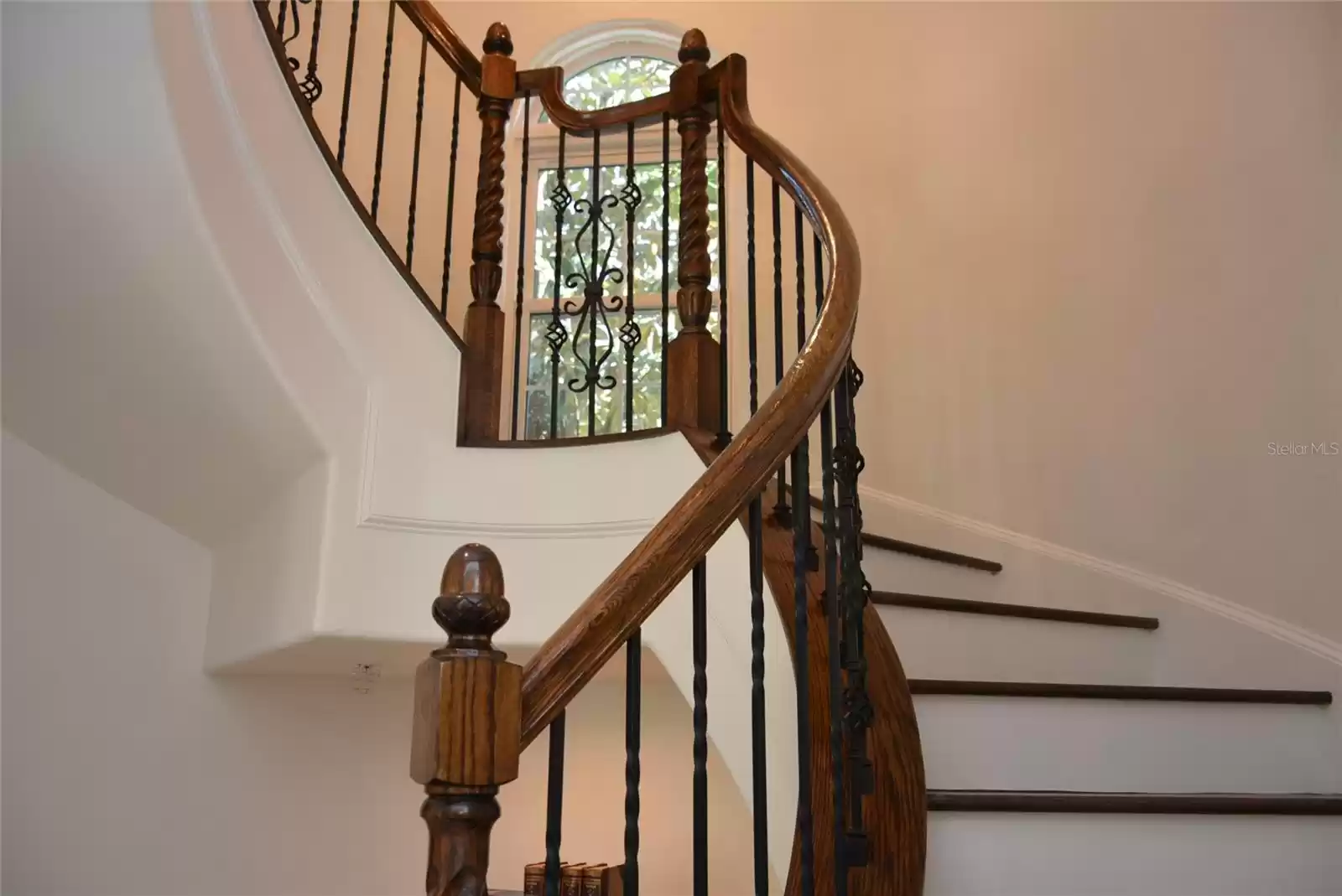 Interior features include an elegant hardwood and wrought-iron spiral staircase rising to the top of the turret and providing access to the treetop terrace a hidden room and bonus storage space