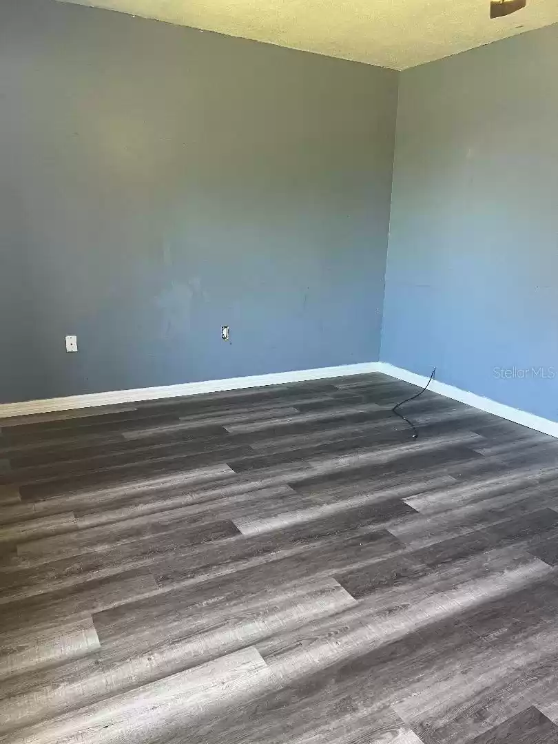 Secondary bedroom, new vinyl flooring and baseboards.