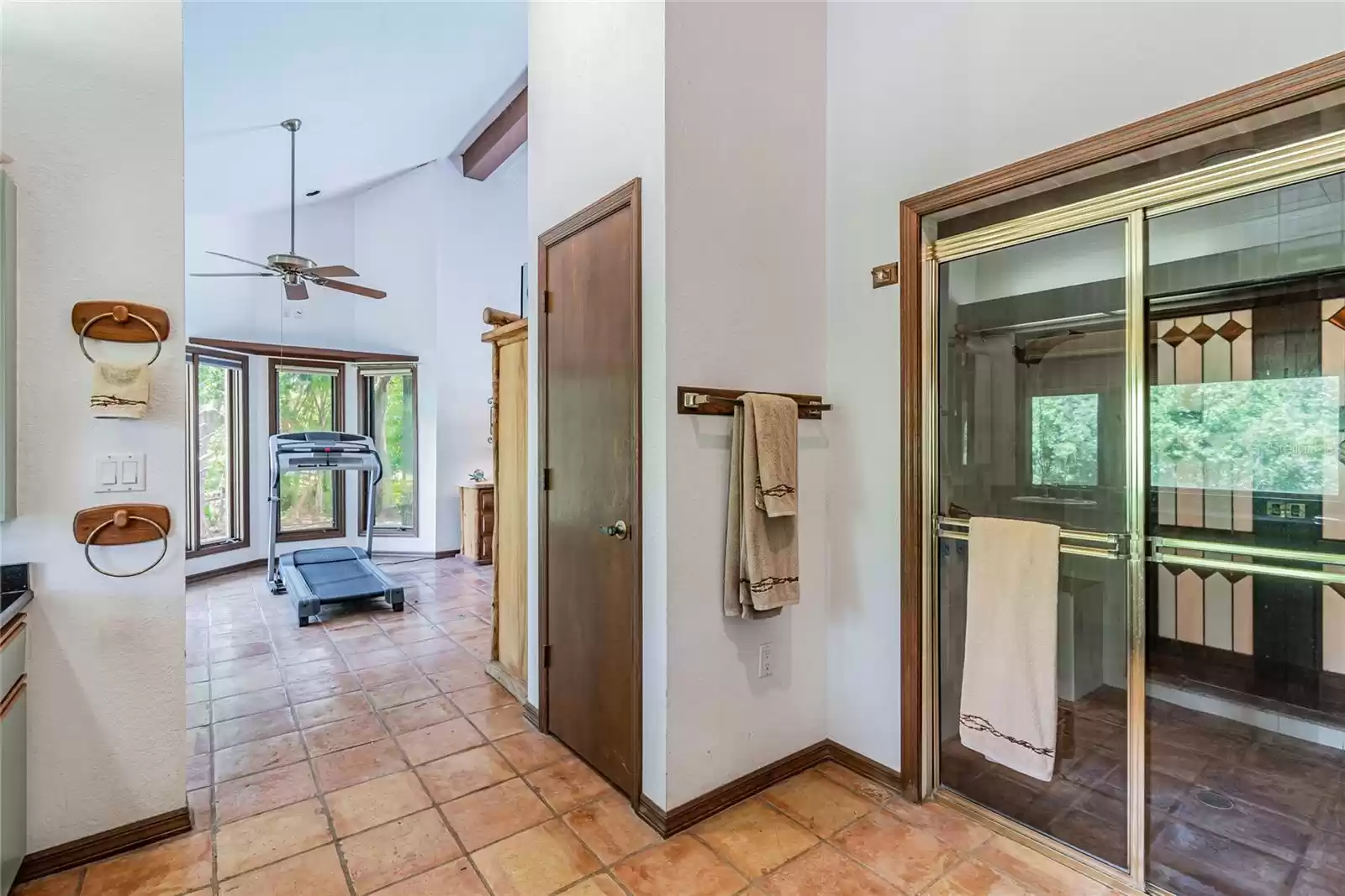 Owner's Ensuite Bathroom with dual sink vanity with large picture window showcasing serene views at the property.